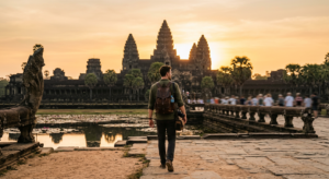 A professional editorial-style photograph capturing a lone traveler calmly walking through a famous